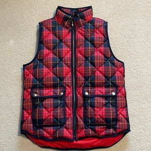 JCrew red and navy blue plaid puffer vest with gold trim.